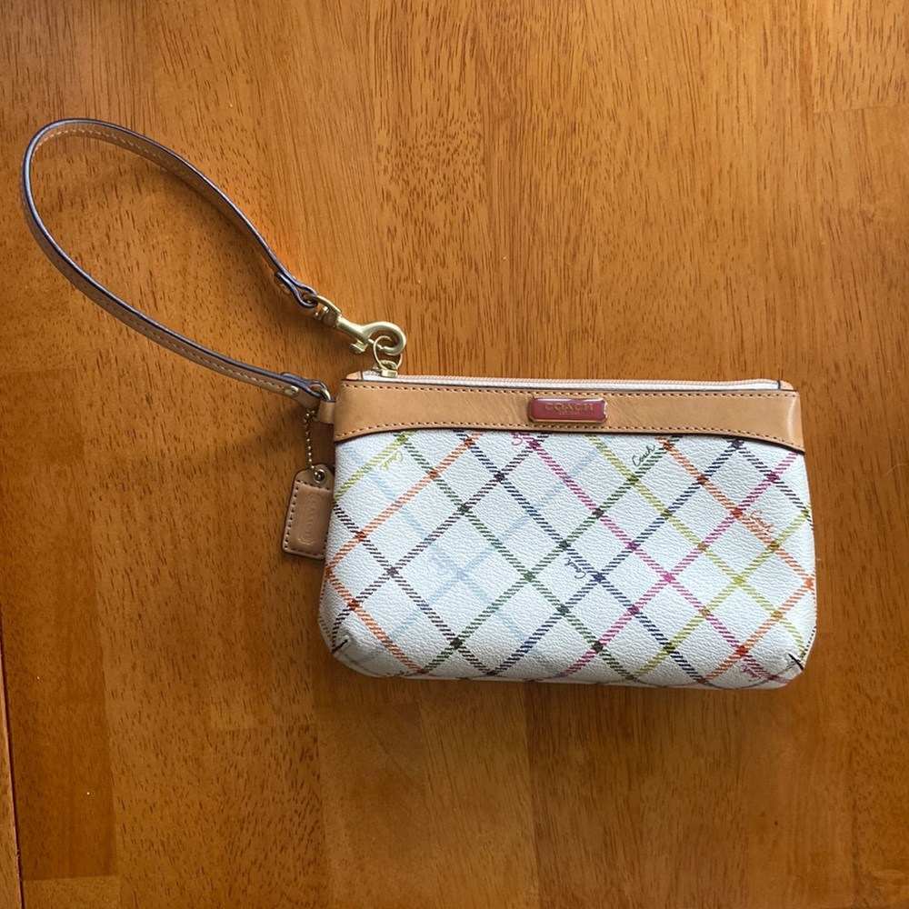 Coach wristlet, white with beige trim and multicolored pattern. 7in L, 4.5 in. H